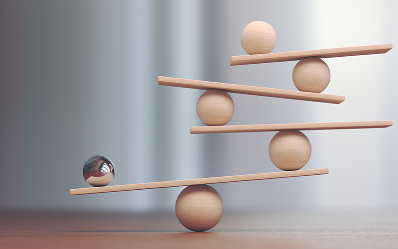 Balls balanced on boards despite apparent imbalance