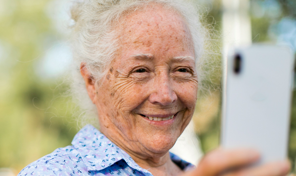Elderly woman smiling on a mobile phone video call